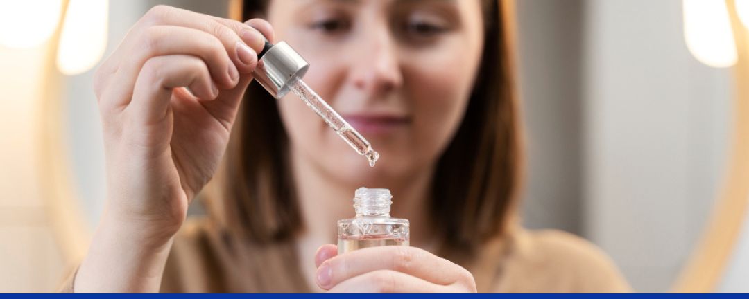 A girl holding a face serum to use it.