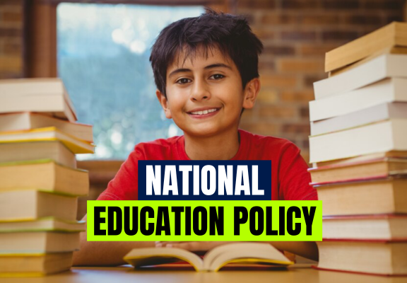 A kid sitting with lots of book around him.